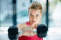 Focused and ferocious. Cropped portrait of an attractive young woman working out with dumbbells.