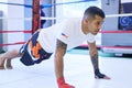 Focused on the fight ahead. a young man doing pushups in the gym. Royalty Free Stock Photo