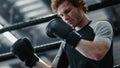 Focused fighter waiting for fight in sport club. Kickboxer wearing boxing gloves Royalty Free Stock Photo