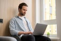 Focused freelancer in casual wear typing on laptop Royalty Free Stock Photo