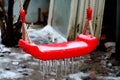 Focused frozen simple red swing for children in the winter Royalty Free Stock Photo