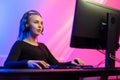 Focused Gamer Girl with Headset Playing Online Video Game on PC Royalty Free Stock Photo