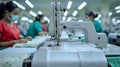 Focused garment workers at sewing machines ensuring precision and quality control in the textile industry Royalty Free Stock Photo