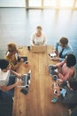 Focused on getting their tasks done. High angle shot of a group of businesspeople having a meeting in an office.