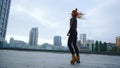 Focused ginger girl riding rollerblades. Roller skater spinning at street Royalty Free Stock Photo