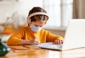 Focused girl making notes during remote education Royalty Free Stock Photo