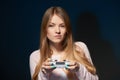 Focused girl playing video game with joystick