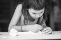 Portrait of focused girl who sculpts a sculpture