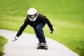 Focused on going fast. Shot of a skateboarder making his way down a lane on his board.