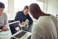 Focused group of diverse colleagues working around an office tab Royalty Free Stock Photo