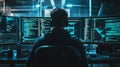 Focused Hacker Working Late at Night on Multiple Monitors
