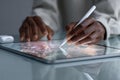Classroom Desk Technology - Hand Using Stylus on Tablet with Concentration for Royalty Free Stock Photo