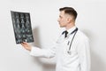 Focused handsome young doctor man holds x-ray radiographic image ct scan mri isolated on white background. Male doctor Royalty Free Stock Photo