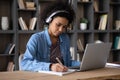 Focused happy young African American woman studying online. Royalty Free Stock Photo