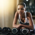 Focused on her fitness goals. a young woman working out with dumbbells at the gym. Royalty Free Stock Photo