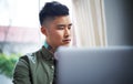 Focused on his designs. a handsome young man working on his laptop at home. Royalty Free Stock Photo