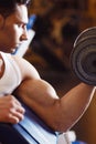 Focused on his form. a handsome young man lifting weights. Royalty Free Stock Photo