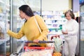 Hispanic woman shopping for milk products in supermarket Royalty Free Stock Photo