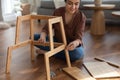 Focused indian woman use simple tools collect self assembly furniture