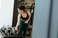 Determined athlete engages in strength training with kettlebells in a modern gym setting during morning hours Royalty Free Stock Photo