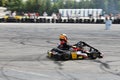 Focused kart racing driver on circuit drifting