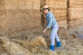 Focused kazakh woman works ear haystacks