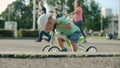 Focused kid making first try on bike. Cute boy riding bike in amusement park Royalty Free Stock Photo