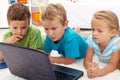 Focused kids looking at laptop computer