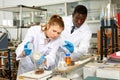 Focused lab technician woman with tubes and worried man technician Royalty Free Stock Photo