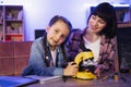 Focused little girl looking camera, working with electron microscope. Royalty Free Stock Photo