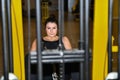 Woman focuses using a leg adductor machine