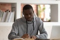 Focused male african american student preparing for final examination.