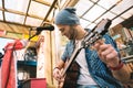 Focused male guitarist setting sound in bar