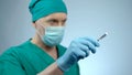 Focused male surgeon holding sharp scalpel in hand, ready to start surgery Royalty Free Stock Photo