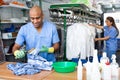 Focused man drycleaner removing spots and stains