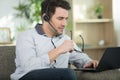 focused man in headset sit on couch working at laptop Royalty Free Stock Photo