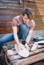 Focused man preparing wooden skateboard for painting