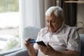 Focused man using mobile phone and making online payment Royalty Free Stock Photo