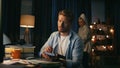 Focused man writing remarks at home closeup. Woman dancing vacuuming at evening