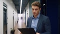 Focused manager looking documents on clipboard. Company ceo walking hallway Royalty Free Stock Photo