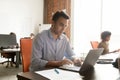 Focused mature businessman working with laptop documents in modern office Royalty Free Stock Photo