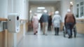 Focused medium shot of AIpowered fallrisk sensor device positioned in a hospital corridor with outoffocus elderly Royalty Free Stock Photo