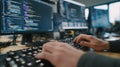 Focused medium shot capturing a coders hands typing framebyframe SKU hotspot embeddings while the surrounding Royalty Free Stock Photo