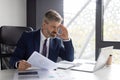 Focused Middle Aged Businessman Working With Documents And Laptop In Office Royalty Free Stock Photo