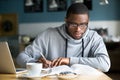 Focused millennial african student making notes while studying i Royalty Free Stock Photo