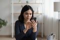 Focused millennial asian woman using mobile phone software applications. Royalty Free Stock Photo