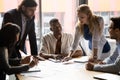 Focused mixed race colleagues listening to teammates. Royalty Free Stock Photo