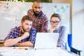 Focused multiethnic group of people working with laptop together Royalty Free Stock Photo