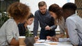 Focused multiethnic business people work together discuss paperwork at meeting Royalty Free Stock Photo