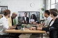 Focused multiracial business people in conference room, looking at a screen Royalty Free Stock Photo